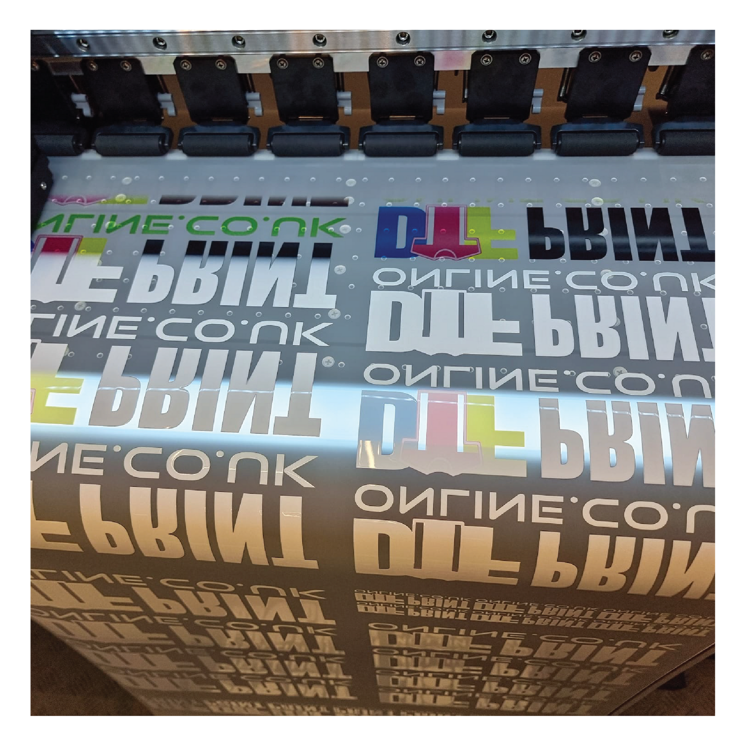 DTF transfer film being printed with colorful designs on DTF printer - DTF Print Online
