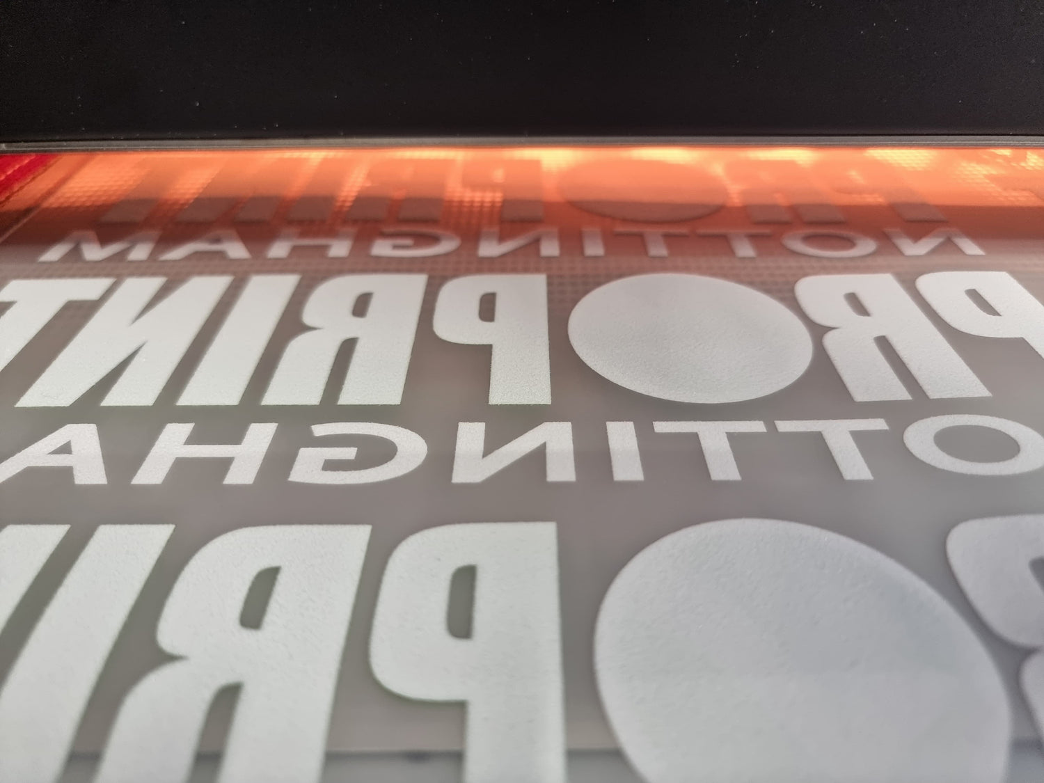 DTF transfer sheet on heat press showing Nottingham Print design - DTF Print Online