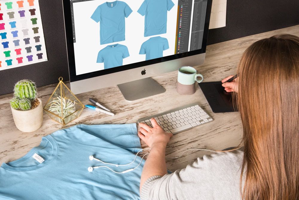 Designer creating custom t-shirt designs on computer for DTF printing - DTF Print Online